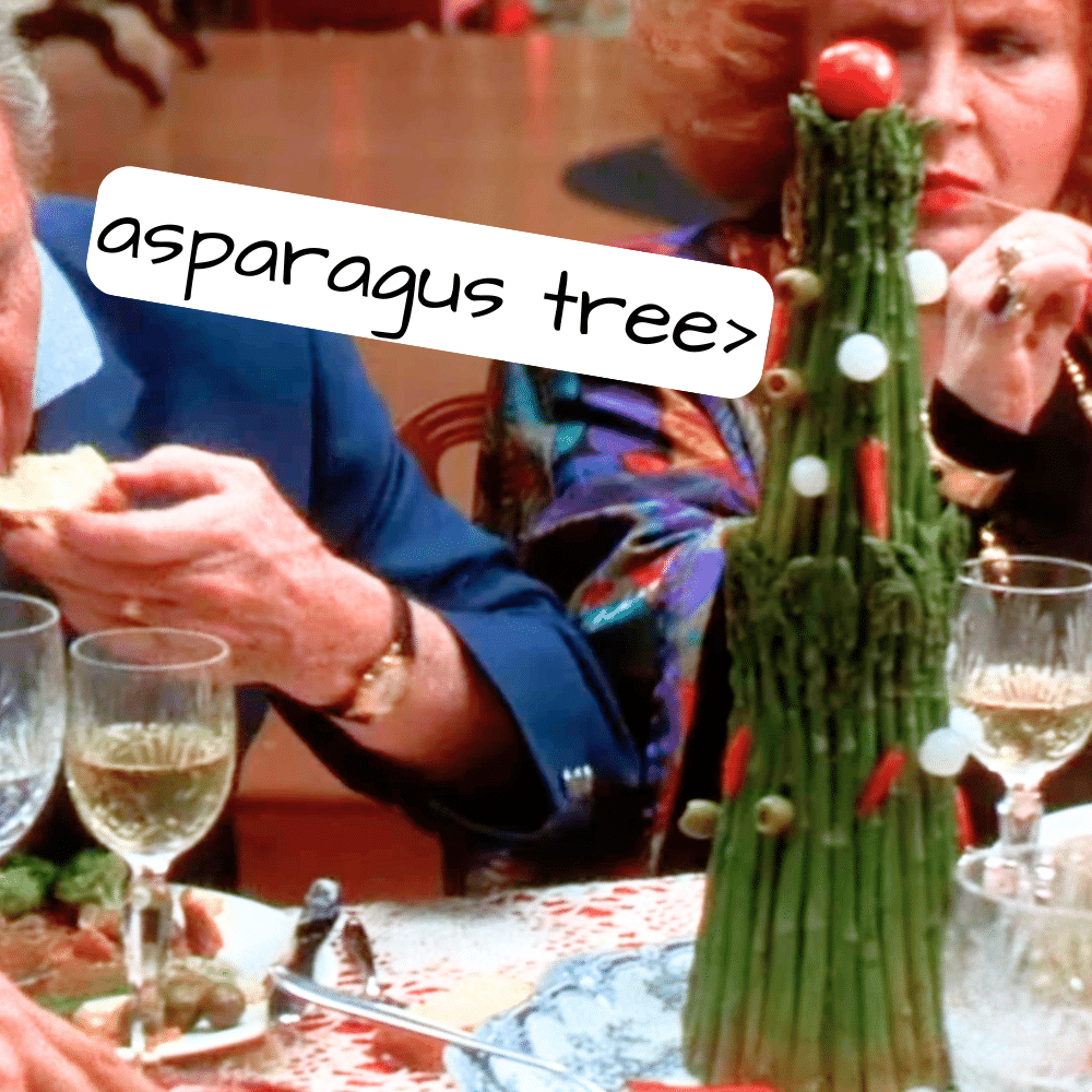 Christmas Vacation Movie Party Menu Asparagus Tower screenshot of Christmas Vacation dinner party scene with Christmas food and Christmas tree made from asparagus