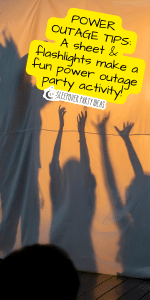 power outage tips - kids playing behind a sheet with flashlights for flashlight shadows