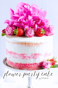 cake with real flowers and strawberries that look like flowers for a flower party cake floral theme